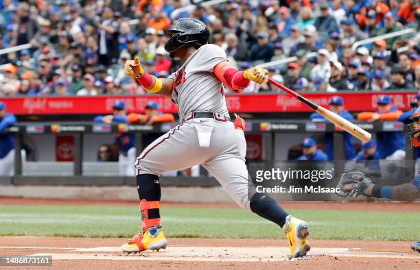 Ronald Acuna Jr. #13 of the Atlanta Braves follows through on a first inning base hit against the New York Mets in game one of a doubleheader at Citi...