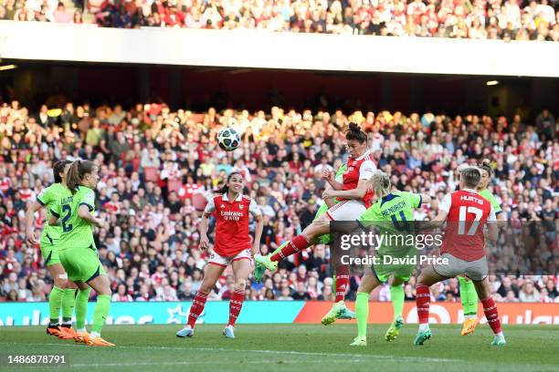 Jennifer Beattie of Arsenal scores the team's second goal whilst under pressure from Kathrin Hendrich of VfL Wolfsburg during the UEFA Women's...