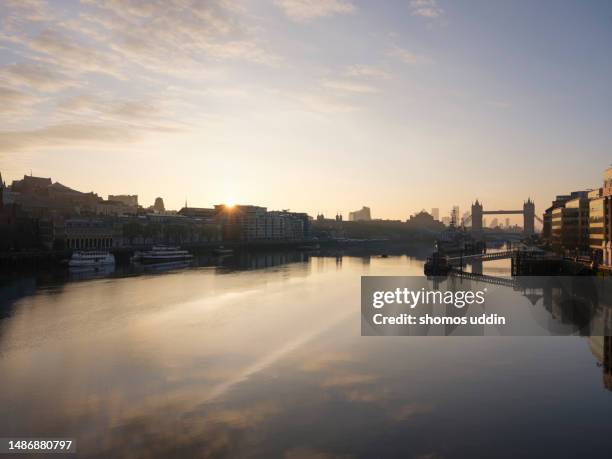 london city skyline across river thames at sunrise - rising sun stock pictures, royalty-free photos & images