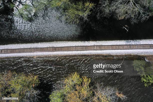 In this aerial view, railroad tracks running along the Mississippi River are surrounded by floodwater on May 01, 2023 near Dubuque, Iowa. Although...