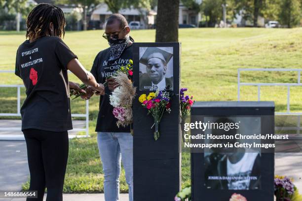 Jonathan Drake cuts flowers as he helps set up for the opening of the Say Their Names Memorial in Emancipation Park on Monday, Sept. 28, 2020 in...