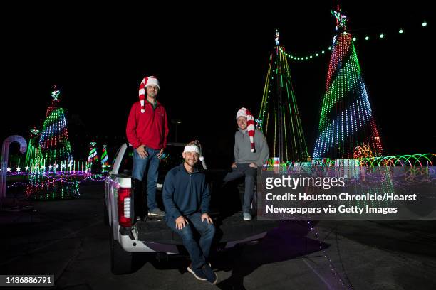 Matt Johnson, left, Jasen Coots and Joe White, co-creators of The Light Park, a new drive-through holiday experience pose for a portrait in the park...