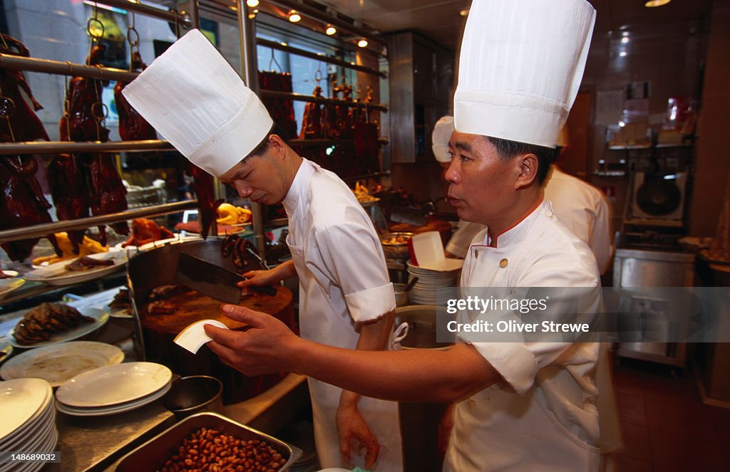 Chefs at work in the Yung Kee Restaurant on Wellington Street, Central, Hong Kong Island