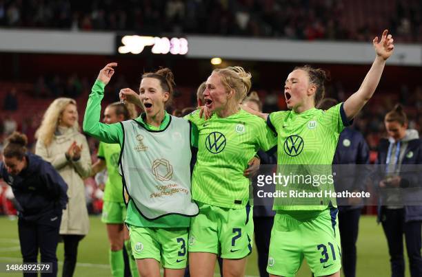 Sara Agrez, Pauline Bremer and Marina Hegering of VfL Wolfsburg celebrate victory after progressing to the Champions League Final after defeating...