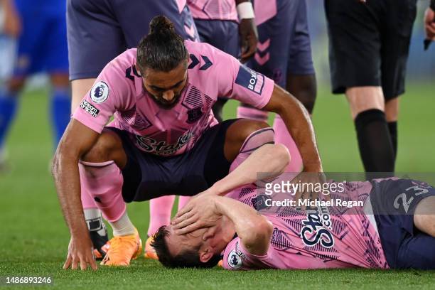 Dominic Calvert-Lewin of Everton comforts Seamus Coleman of Everton as he goes down with an injury during the Premier League match between Leicester...