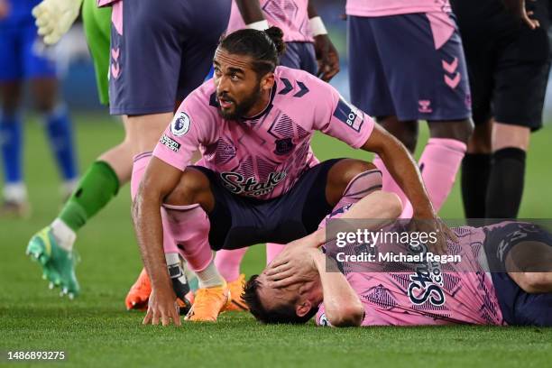 Dominic Calvert-Lewin of Everton comforts Seamus Coleman of Everton as he goes down with an injury during the Premier League match between Leicester...