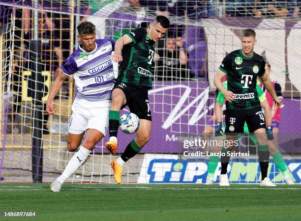 Matija Ljujic of Ujpest FC fights for the possession with Amer Gojak of Ferencvarosi TC in front of Mats Knoester of Ferencvarosi TC during the...