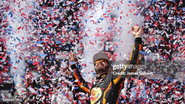 Martin Truex Jr., driver of the Bass Pro Shops Toyota, celebrates in victory lane after winning the NASCAR Cup Series Würth 400 at Dover...