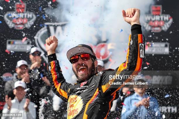 Martin Truex Jr., driver of the Bass Pro Shops Toyota, celebrates in victory lane after winning the NASCAR Cup Series Würth 400 at Dover...