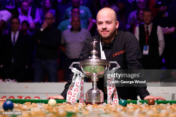 Luca Brecel of Belgium celebrates with the Cazoo World Snooker Championship trophy following victory in the Final match against Mark Selby of England...
