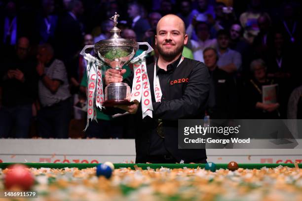 Luca Brecel of Belgium celebrates with the Cazoo World Snooker Championship trophy following victory in the Final match against Mark Selby of England...