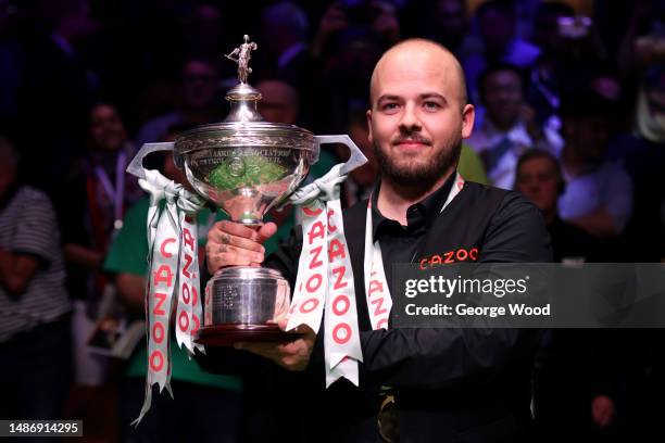 Luca Brecel of Belgium celebrates with the Cazoo World Snooker Championship trophy following victory in the Final match against Mark Selby of England...