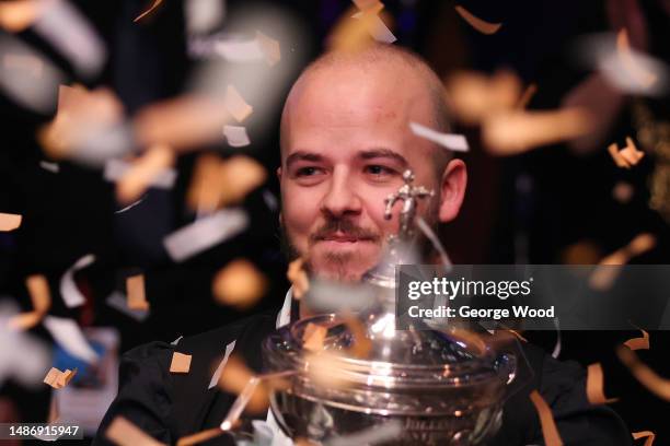 Luca Brecel of Belgium celebrates with the Cazoo World Snooker Championship trophy following victory in the Final match against Mark Selby of England...