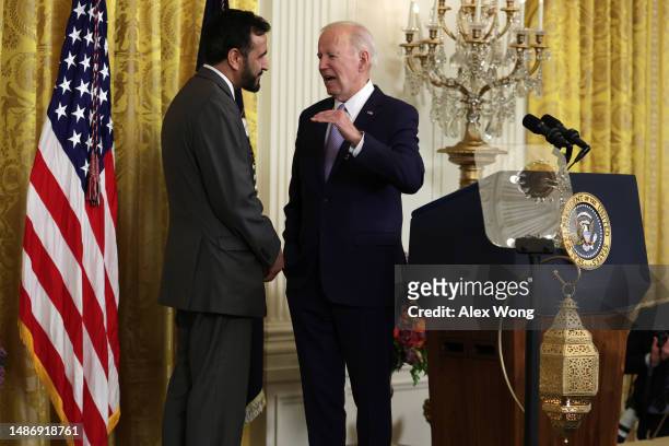 President Joe Biden talks to Founder and Executive Director of MakeSpace Imam Makhdoom Zia during a reception celebrating Eid-al-Fitr in the East...