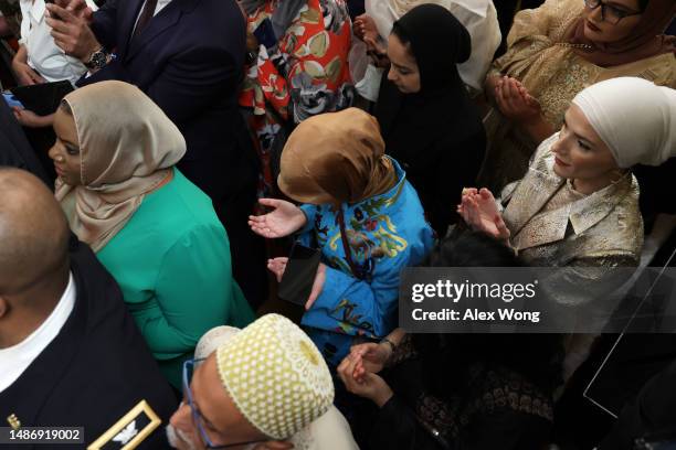Guests participate in a prayer during a reception celebrating Eid-al-Fitr in the East Room of the White House on May 1, 2023 in Washington, DC. The...