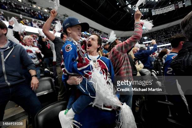 Fans of the Colorado Avalanche cheer against the Seattle Kraken in Game Seven of the First Round of the 2023 Stanley Cup Playoffs at Ball Arena on...