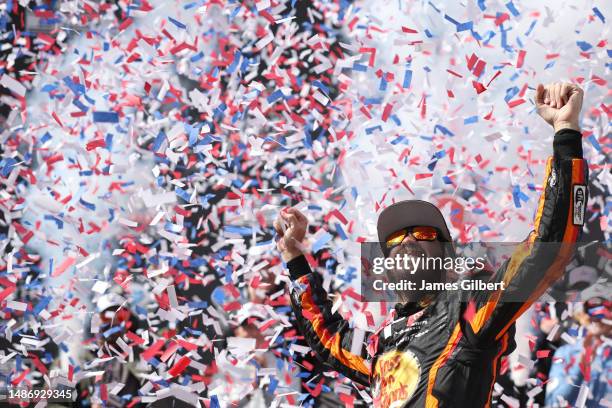 Martin Truex Jr., driver of the Bass Pro Shops Toyota, celebrates in victory lane after winning the NASCAR Cup Series Würth 400 at Dover...