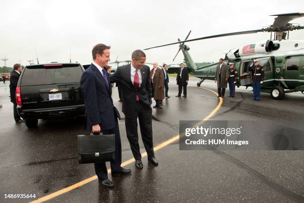 President Barack Obama and British Prime Minister David Cameron prepare to board Marine One at the Deerhurst Resort landing zone in Muskoka, Canada,...