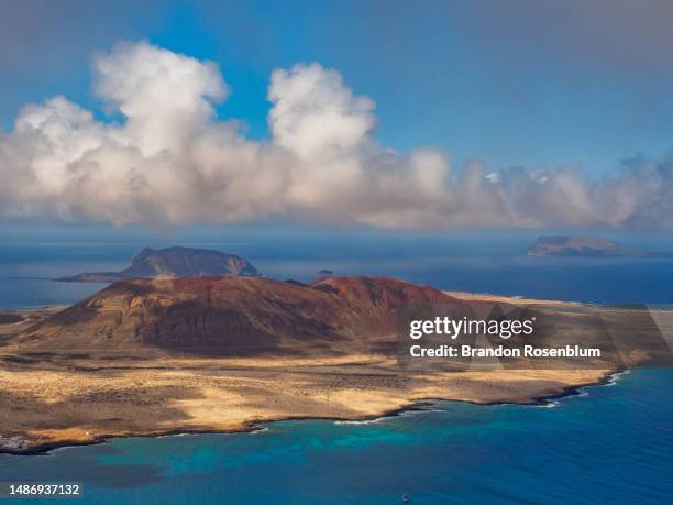 view of la graciosa from the island of lanzorote in the canary islands - paisaje volcánico fotografías e imágenes de stock
