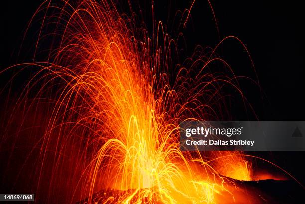 similtaneous explosive eruptions from both vents of stromboli volcano, at night. - isole eolie stock pictures, royalty-free photos & images