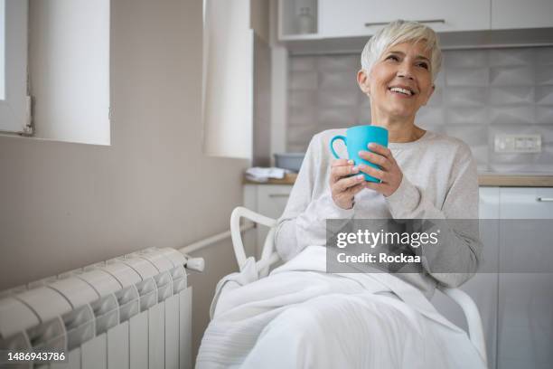 shot of a senior woman enjoying a tea - shivering house stock pictures, royalty-free photos & images