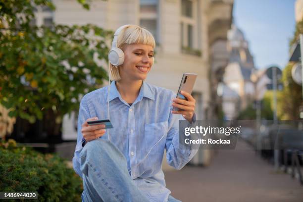 woman using her credit card to shop online - online payment stock pictures, royalty-free photos & images