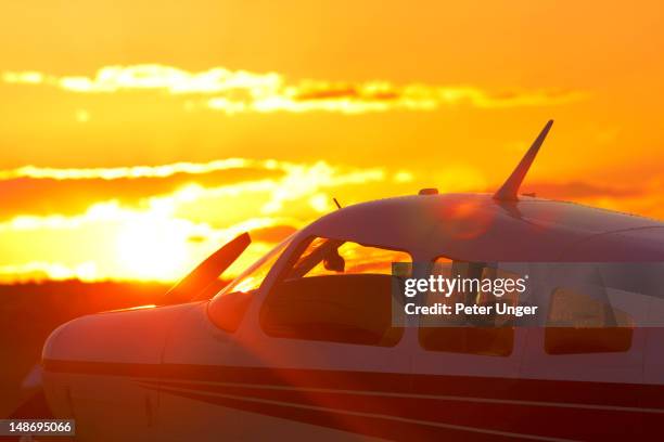 sunset behind small aircraft at birsdville airfield. - air strip stock pictures, royalty-free photos & images