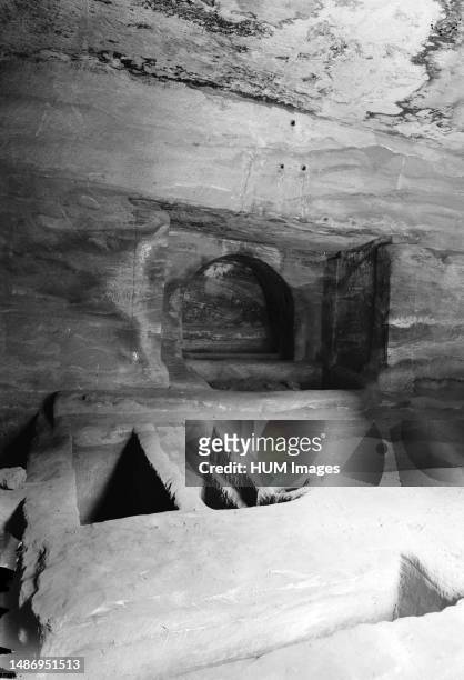 Petra . Lower Siq. Tomb interior in lower Siq. Floor graves and loculi Location: Jordan--Petra ca. 1920.