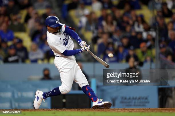 Mookie Betts of the Los Angeles Dodgers hits a two-run ground-rule double in the fifth inning against the Philadelphia Phillies at Dodger Stadium on...