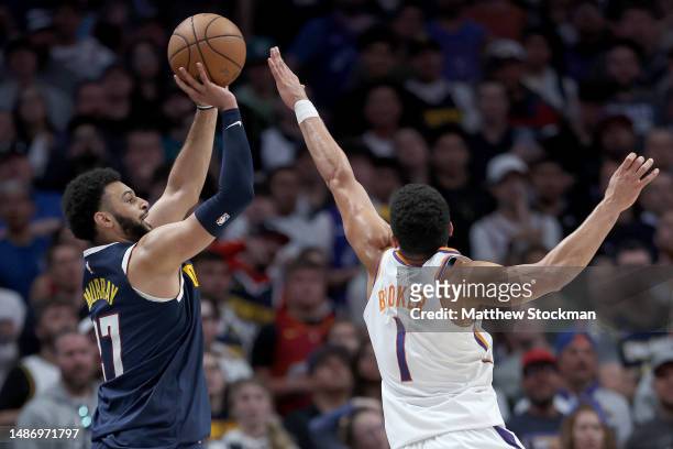Jamal Murray of the Denver Nuggets puts up a shot against Devin Booker of the Phoenix Suns in the fourth quarter during Game Two of the NBA Western...
