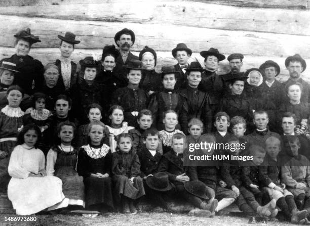 Pupils and parents outside the old log schoolhouse at Fraser Lake, Carlow, Ontario ca. 1899.