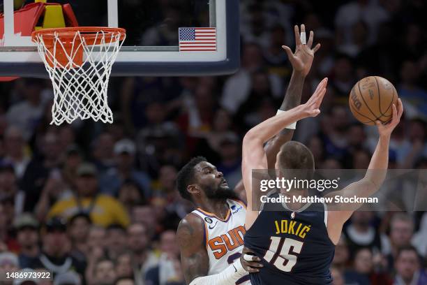 Nikola Jokic of the Denver Nuggets puts up a shot against Deandre Ayton of the Phoenix Suns in the fourth quarter during Game Two of the NBA Western...