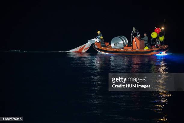 Support teams collect the parachutes shortly after the SpaceX Crew Dragon Endeavour spacecraft landed with NASA astronauts Shane Kimbrough and Megan...