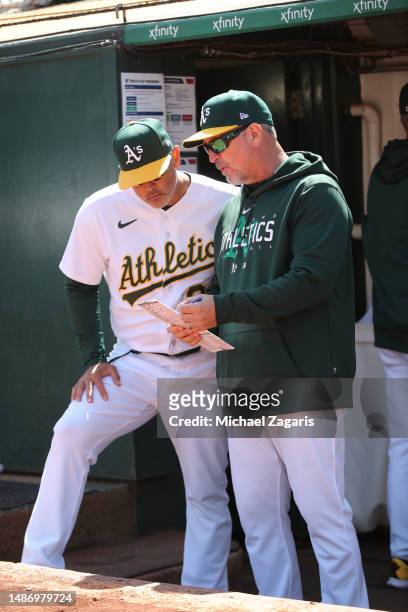 Bench Coach Darren Bush and Ramon Hernandez of the Oakland Athletics during the game against the Chicago Cubs at RingCentral Coliseum on April 19,...