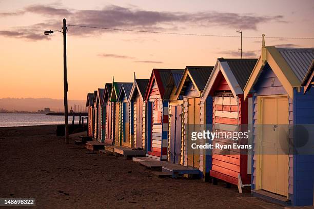 brighton bathing boxes at dusk, dendy street beach. - brighton beach stock pictures, royalty-free photos & images