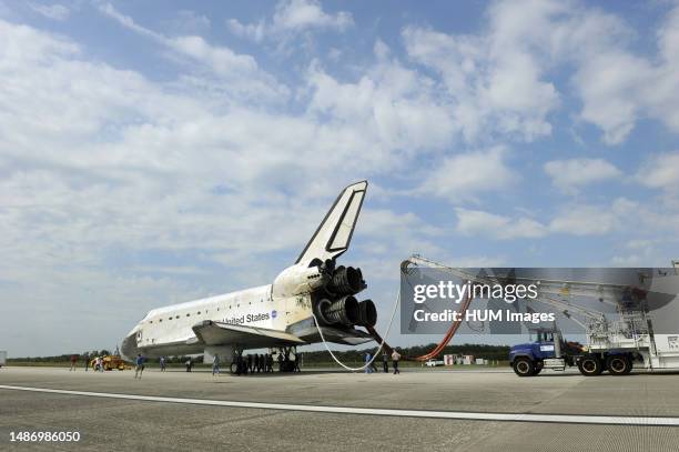 Space shuttle Atlantis begins its slow trek from the Shuttle Landing Facility to an orbiter processing facility at NASA's Kennedy Space Center in...