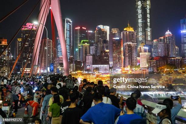 Tourists visit Qiansimen Jialing River Bridge during the May Day holiday on May 1, 2023 in Chongqing, China.