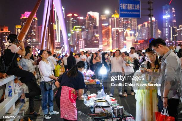 Tourists visit Qiansimen Jialing River Bridge during the May Day holiday on May 1, 2023 in Chongqing, China.