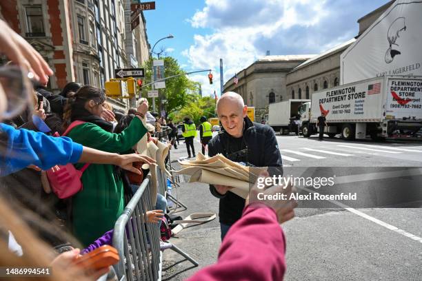 Ted Resnick, owner of Event Carpet - Flemington Department Store, hands out excess pieces of the red carpet to fans ahead of The 2023 Met Gala...