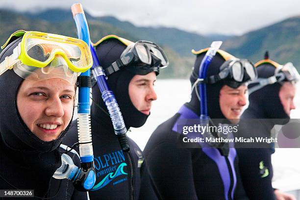 a group gets ready for a dolphin swim in kaikoura - カイコウラ ストックフォトと画像