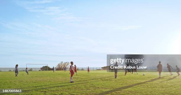 children, football and sky mockup with a team playing a game on a field for fitness, competition or recreation. kids, soccer and sports with a group of youth on a grass pitch for a match outdoor - kids sports uniform template stock pictures, royalty-free photos & images