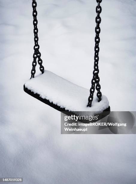 snowy children's swing on a children's playground, playground, sw photo, winter landscape, mondsee, salzkammergut, upper austria, austria - abandoned playground stock pictures, royalty-free photos & images