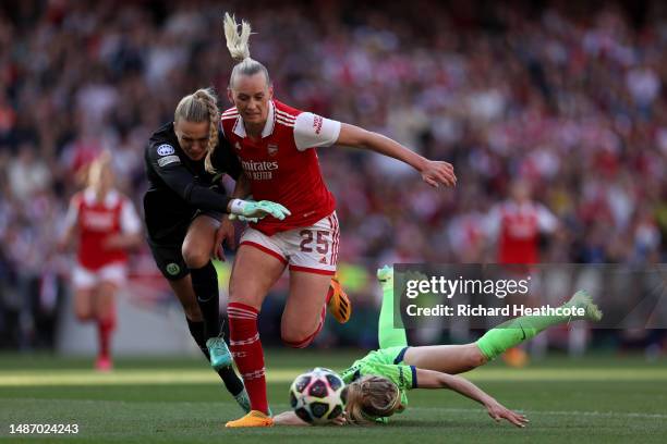 Stina Blackstenius of Arsenal is challenged by Merle Frohms and Kathrin Hendrich of VfL Wolfsburg, before going on to score the teams first goal,...