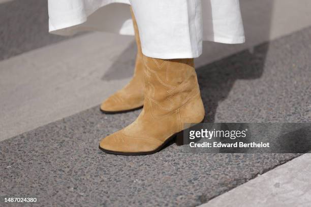Diane Batoukina wears a white square-neck / linen belted long dress, brown suede block heels / pointed ankle boots , during a street style fashion...