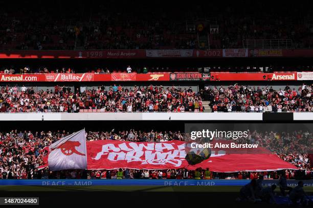 Arsenal fans display a flag as they show their support prior to the UEFA Women's Champions League semifinal 2nd leg match between Arsenal and VfL...