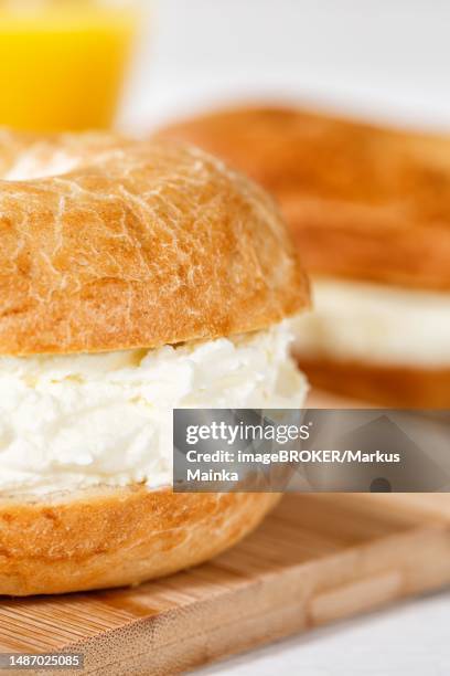bagel sandwich for breakfast topped with cream cheese close-up in stuttgart, germany - cream cheese stock pictures, royalty-free photos & images