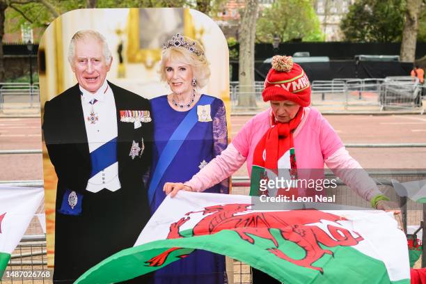 Royalist Anne Daley stands with a cardboard standee of King Charles and Queen Camilla as she marks her spot on the route of the Coronation near...