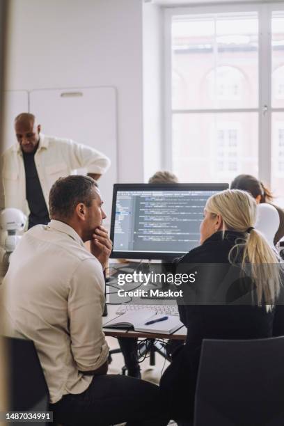 professor and phd student discussing over desktop pc in innovation lab - code 41 stock pictures, royalty-free photos & images