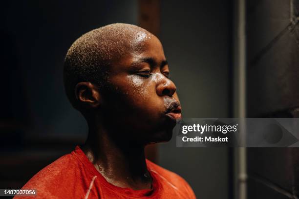 tired female athlete with eyes closed after working out in gym - svett bildbanksfoton och bilder
