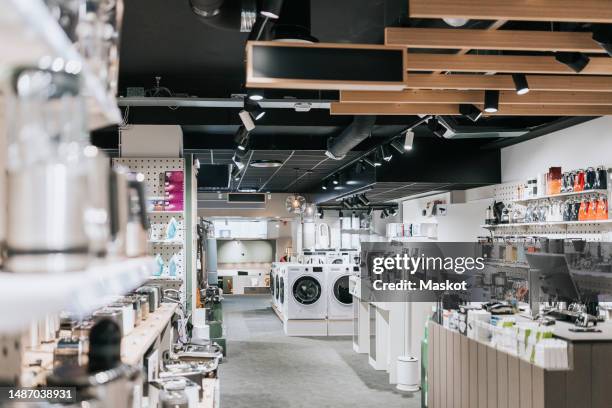 interior of electronics store with various appliances arranged for sale - huishoudelijke apparatuur stockfoto's en -beelden